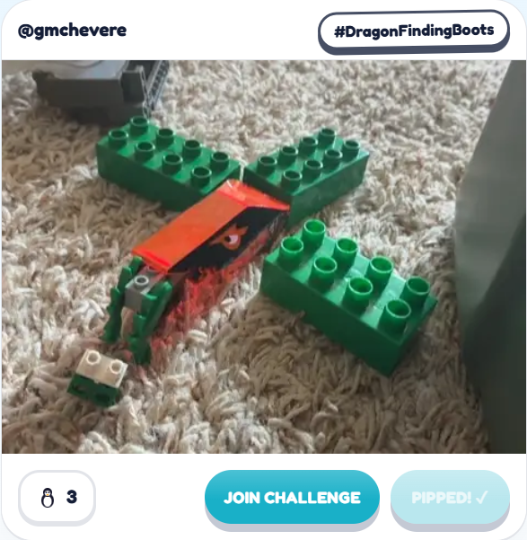 A second Fast Brix! gallery build by @gmchevere for the same #DragonFindingBoots prompt: a green-winged LEGO dragon with an orange and red body sprawled on the carpet beside a small white brick.
